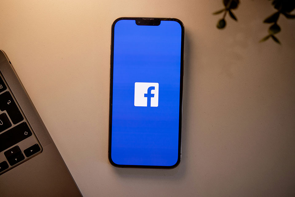 A smart phone with the Facebook logo on the screen