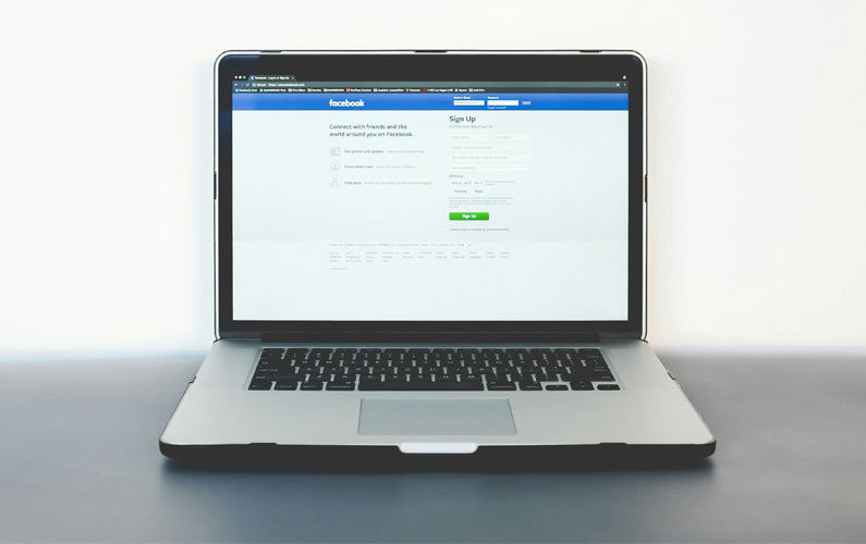 A laptop with the Facebook login screen
