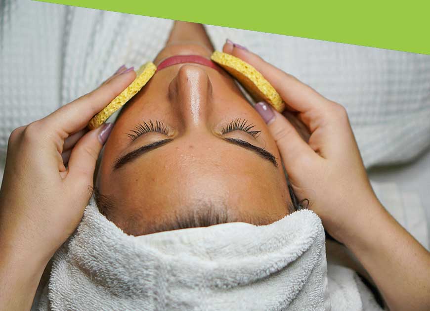 Woman receiving facial treatment