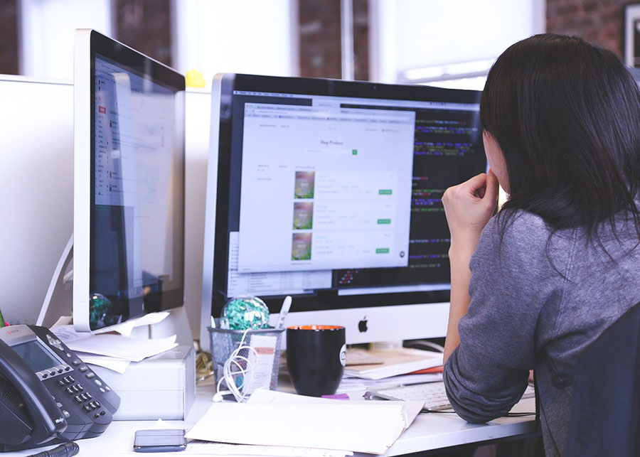 A marketer building a Facebook campaign at a desktop.