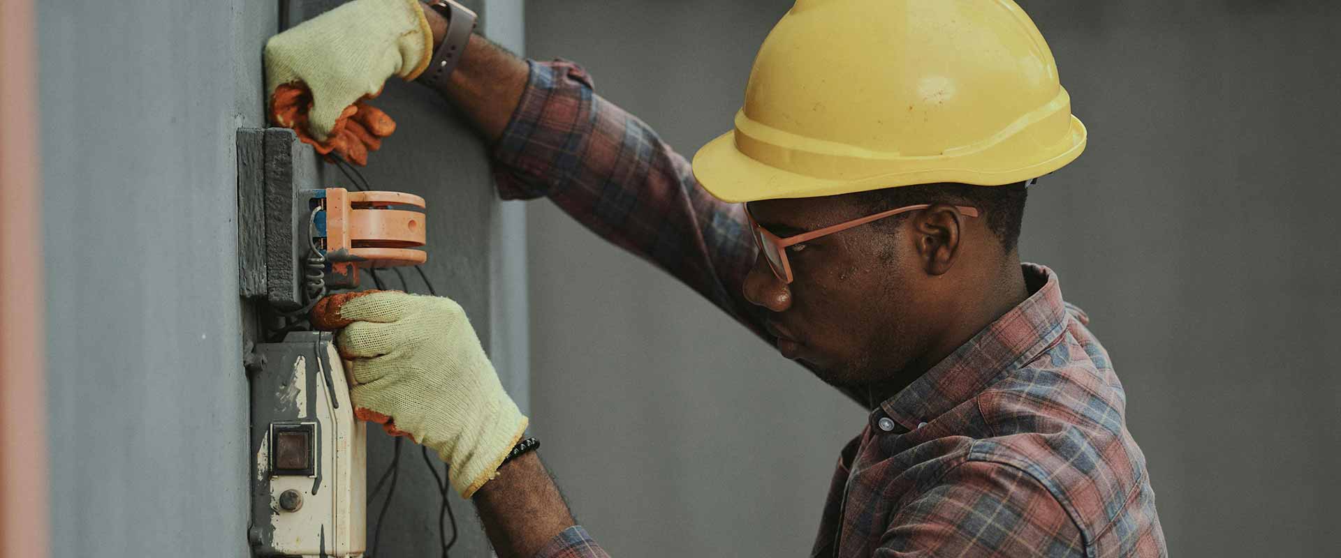 Electrician working with wires on a wall