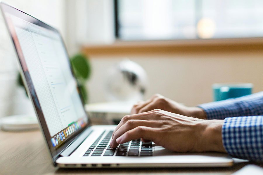 A business owner working on their website on a laptop.