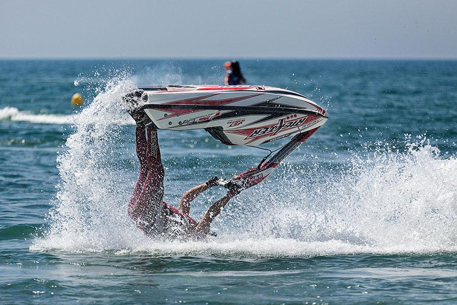 Someone on a seadoo that is upside down.