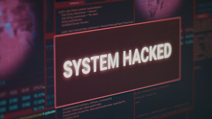 computer monitor showing hacked system alert message flashing screen dealing with hacking cyber crime