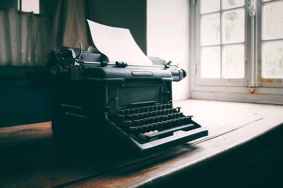 An old typewriter on a table.